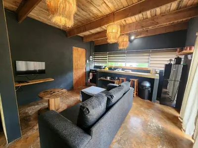 a living room with a couch and a table at Hartbeest Bush Stay #3 in Hartbeespoort