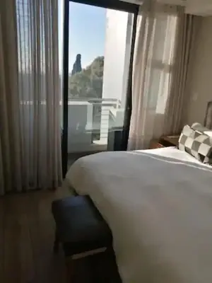 a hotel room with a bed and a window at Premier Lifestyle at The Regency in Pretoria