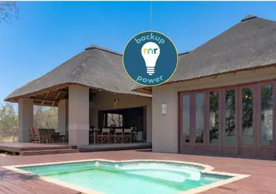 a house with a light bulb on top of it at 203 Zebula - 5 Bedroom 20 sleeper in Mabula