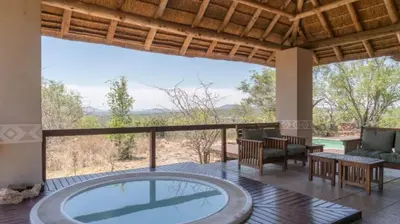 an image of a house with a hot tub in a patio at 203 Zebula - 5 Bedroom 20 sleeper in Mabula