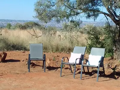 two chairs sitting next to each other in the dirt at KGOLA SAFARIS in Rosslyn