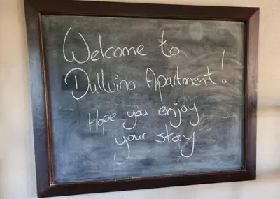 a chalkboard with a sign that says welcome to quilting equipment at DullVino Apartment 8 at Millers Cove in Dullstroom