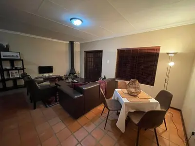 a living room with a couch and a table at DullVino Apartment 8 at Millers Cove in Dullstroom