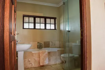 a bathroom with a sink and a toilet and a shower at DullVino Apartment 8 at Millers Cove in Dullstroom