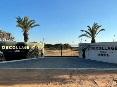 a gate at the entrance to a compound with palm trees at Decollage Estate in Polokwane