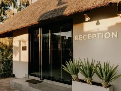 a facade of a building with a thatch roof at Decollage Estate in Polokwane