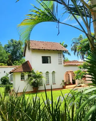 a large white house with a red roof at The Bardolino Artists Retreat in Nelspruit