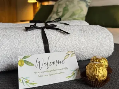 a welcome sign and a basket of food on a towel at Seven Olives Guest Rooms in Thabazimbi
