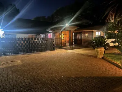 a house at night with a potted plant at Seven Olives Guest Rooms in Thabazimbi