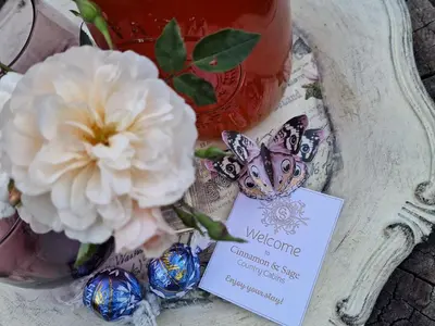 a butterfly and flowers in a vase with a sign at Cinnamon & Sage Country Cabins in Dullstroom