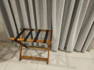 a wooden bench sitting in front of a curtain at Elson Manor Guesthouse in Tzaneen