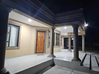 a room with columns and a door on a house at Elson Manor Guesthouse in Tzaneen