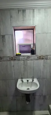 a bathroom with a sink and a mirror at Cozy Little Nest in Pretoria