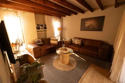 a living room with a couch and a table at Bushveld Jewel - Close to Kruger in Hoedspruit