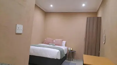 a bedroom with a bed in a room at Cozy Airport Stay in Kempton Park