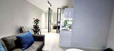 a living room with a couch and a table at Xquisite Ellipse Apartment in Midrand