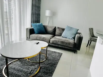 a living room with a couch and a coffee table at Xquisite Ellipse Apartment in Midrand