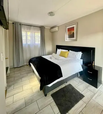 a bedroom with a large bed in a room at The Eden Boulders Hotel and Resort Midrand in Midrand