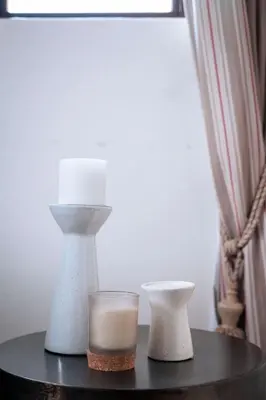 a table with a candle and two vases on it at White River Country Estate - Self Catering - AMH Home in White River