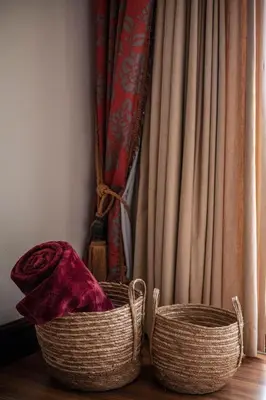 two baskets sitting on a floor next to a curtain at White River Country Estate - Self Catering - AMH Home in White River