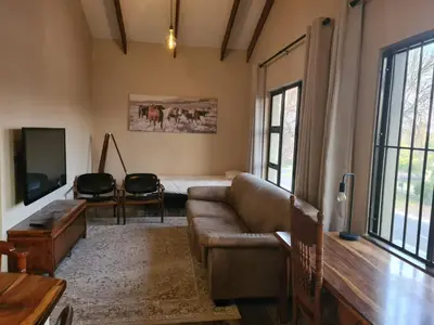 a living room with a couch and a table at Stay@Walter in Pretoria