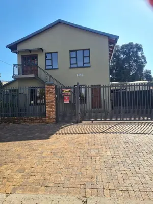 a house with a fence and a brick driveway at Stay@Walter in Pretoria