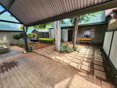 an open patio with a tree in the middle at The Grace in Pretoria