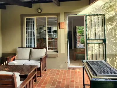 a living room with a couch and a table at The Grace in Pretoria