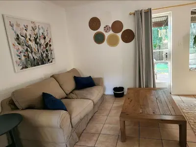 a living room with a couch and a wooden table at The Grace in Pretoria
