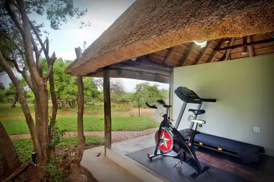 a room with a gym with a bike in it at Itaga Luxury Private Game Lodge in Bela-Bela