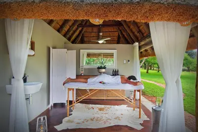 a man laying on a bed in a room at Itaga Luxury Private Game Lodge in Bela-Bela