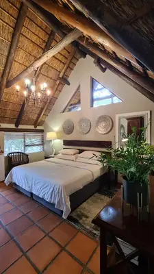 a bedroom with a large bed in a attic at Itaga Luxury Private Game Lodge in Bela-Bela