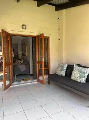 a porch with a couch on a house at Iyana Place in Midrand