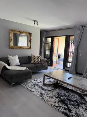 a living room with a couch and a coffee table at Iyana Place in Midrand