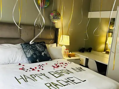 a bedroom with a happy new year sign on a bed at Kings View Exclusive Villas (KVEV) in Petronella