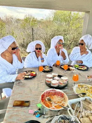 a group of women sitting at a table eating food at Kings View Exclusive Villas (KVEV) in Petronella