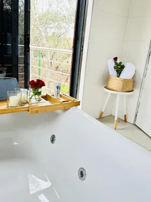 a bath tub in a room with a window at Kings View Exclusive Villas (KVEV) in Petronella