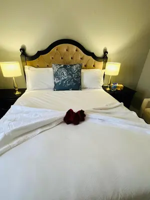 a large white bed with a red bow on it at Kings View Exclusive Villas (KVEV) in Petronella