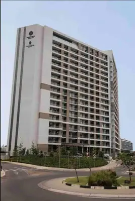 a large building with a sign on the side of it at Entire Studio Apartment at The Capital Triology in Pretoria