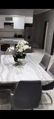 a table with a vase of flowers on top of it at Kings view exclusive villas (KVEV) in Pretoria-Noord