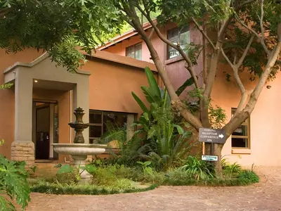 a building with a fountain in front of it at Schoongezich Guesthouse in Pretoria