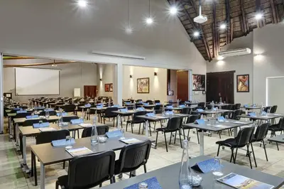 a large room with tables and chairs and a whiteboard at Zebula Golf Estate and Spa - Zebula Golfers Lodge in Mabula