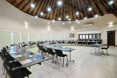 a large room with tables and chairs in it at Zebula Golf Estate and Spa - Zebula Golfers Lodge in Mabula