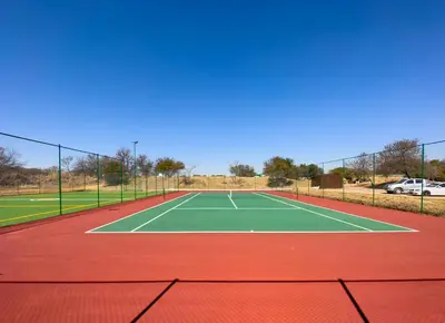 a tennis court on a tennis court at Zebula Golf Estate and Spa - Zebula Golfers Lodge in Mabula