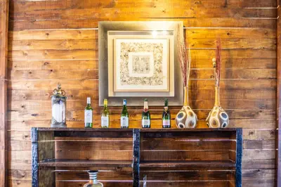 a bar with bottles of wine on a wooden wall at Zebula Golf Estate and Spa - Zebula Golfers Lodge in Mabula