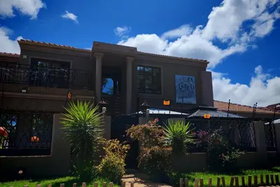 a large house with plants in front of it at Lady D Exclusive Abode in Polokwane