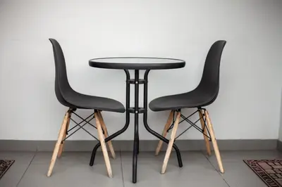 two black chairs around a black table in a room at Yalla Yalla Boutique Hotel in Witbank