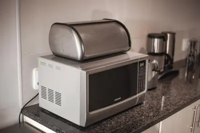 a microwave with a toaster sitting on top of it at Yalla Yalla Boutique Hotel in Witbank