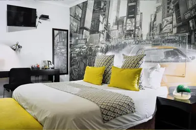 a bedroom with a large bed with yellow pillows at Yalla Yalla Boutique Hotel in Witbank