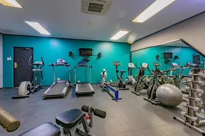 a gym with several treadmills and exercise machines at Sanbonani Hotel in Hazyview